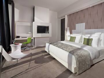 a room with a bed and a television