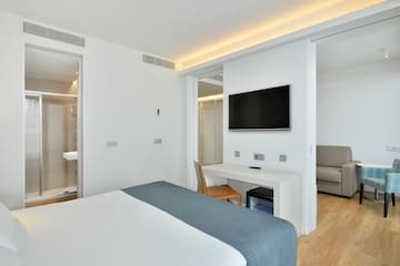 a room with a bed and a tv