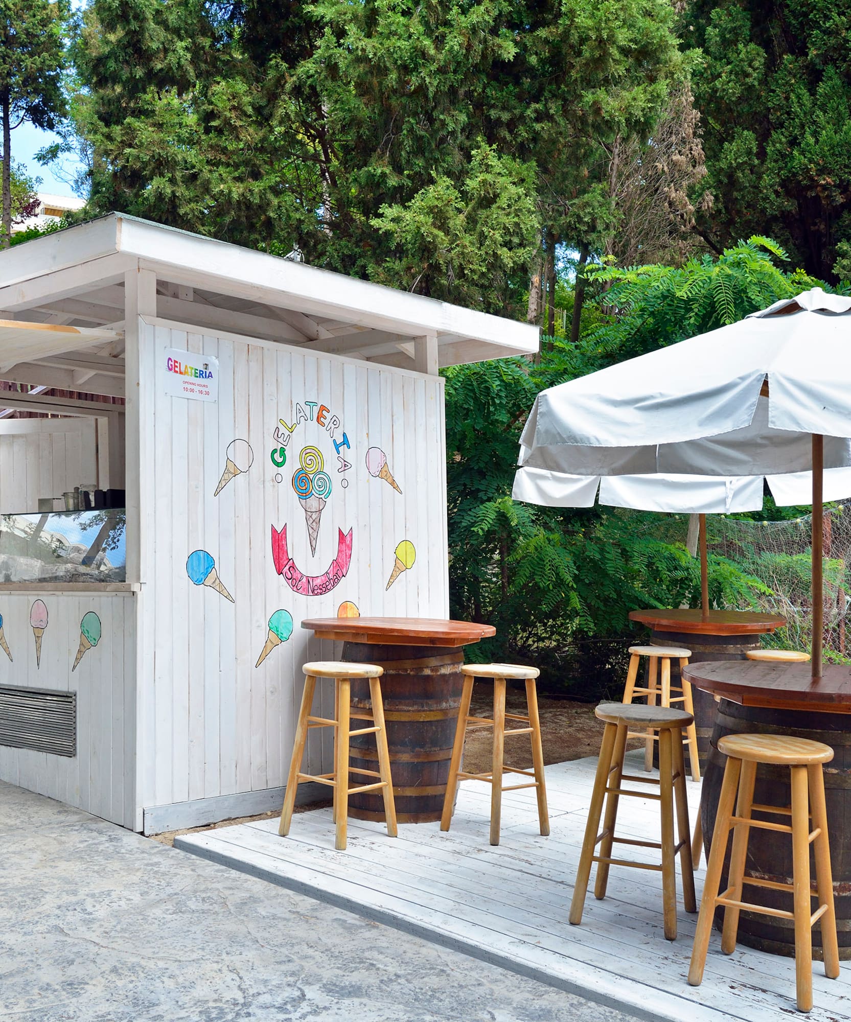 a white booth with tables and umbrellas