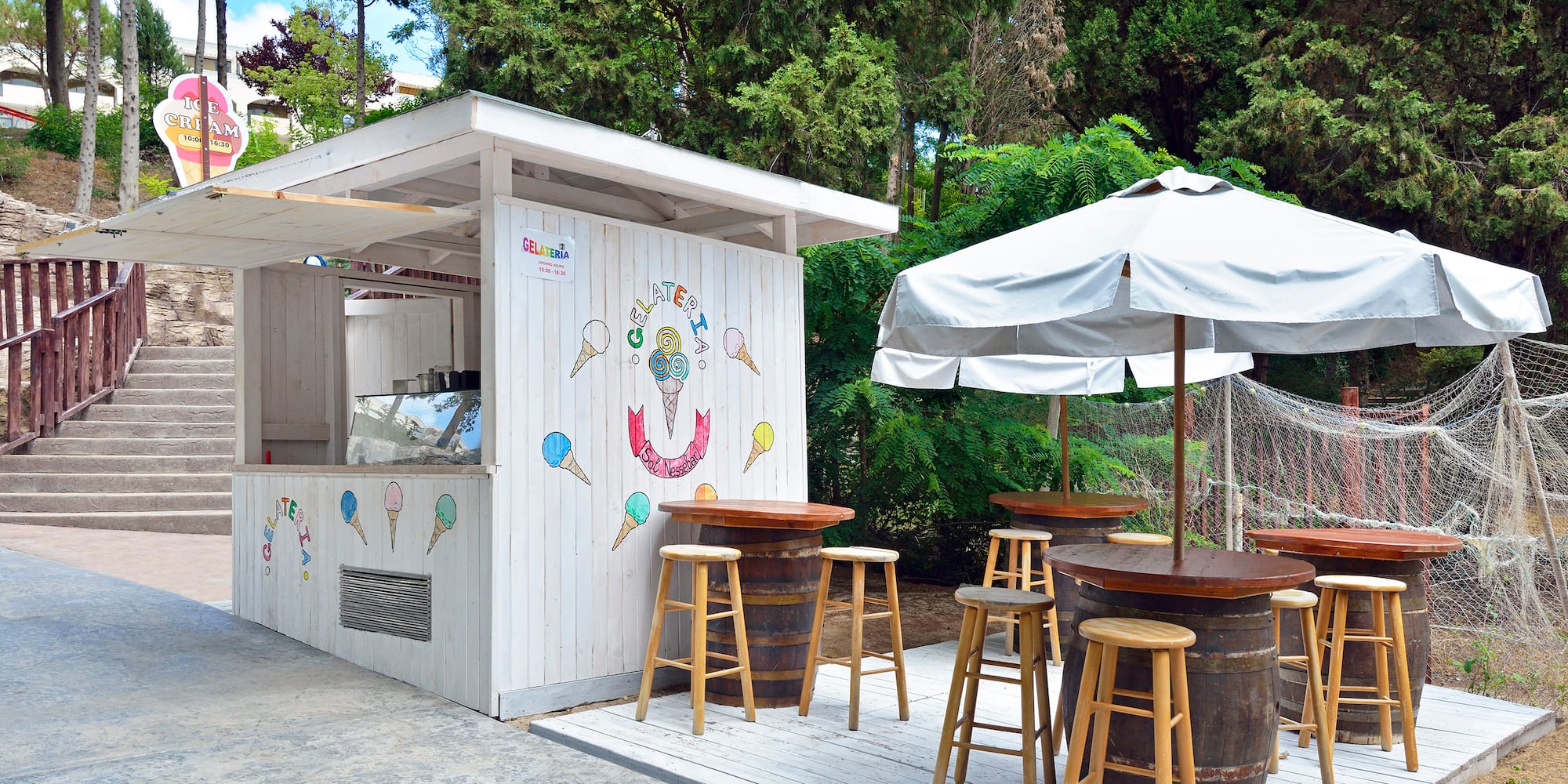 a white booth with tables and umbrellas