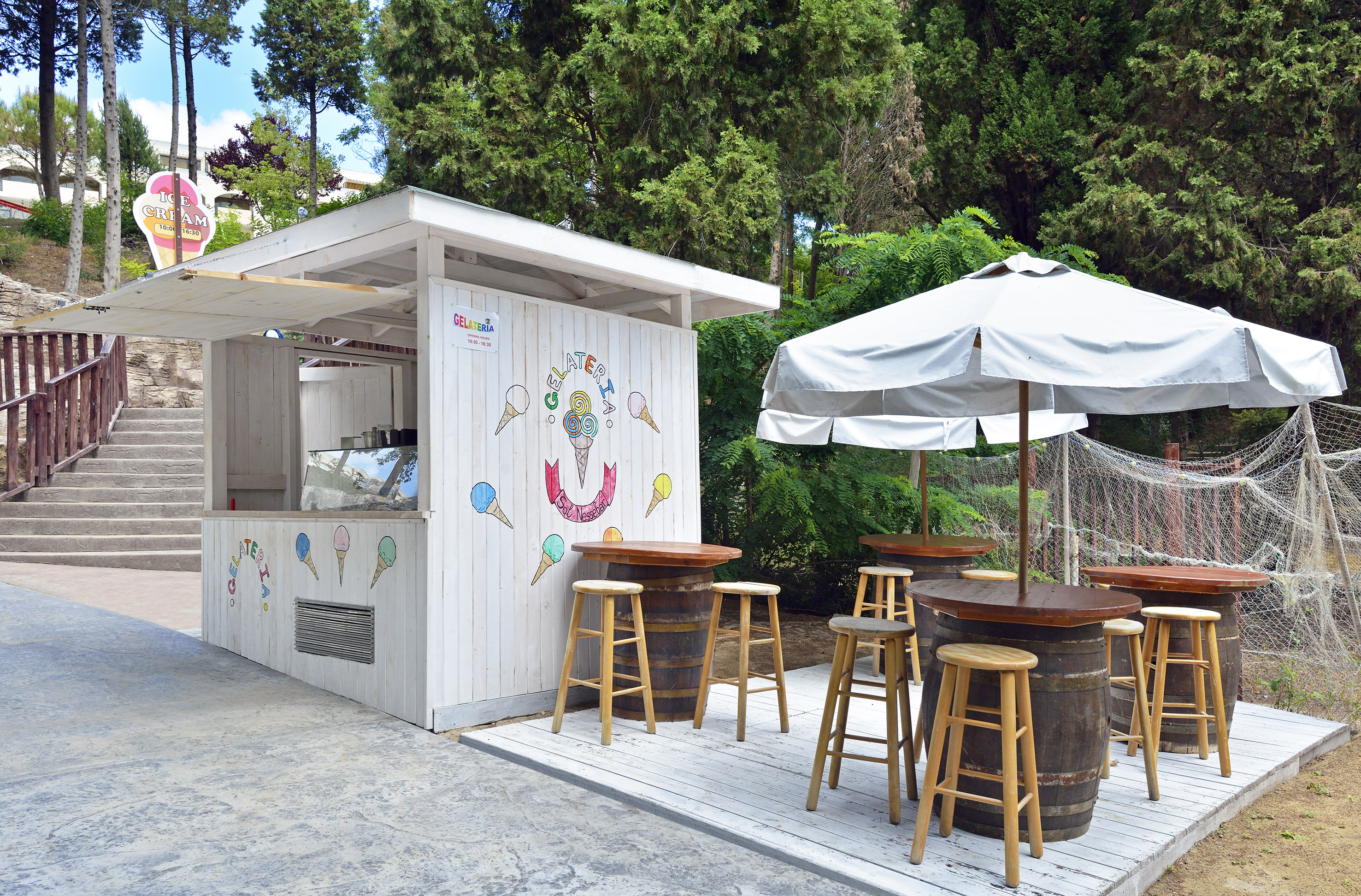 a white booth with tables and umbrellas