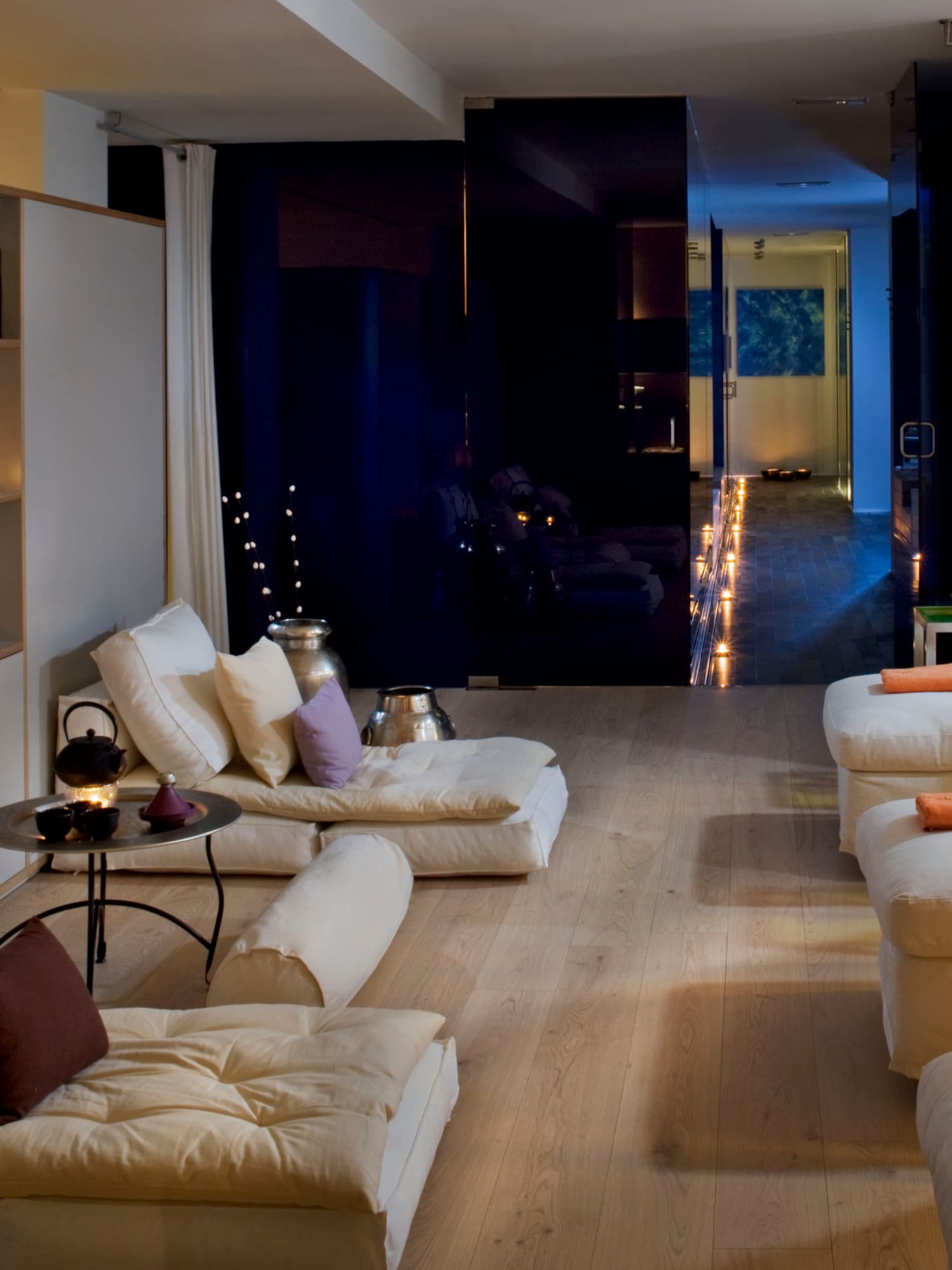 a room with white couches and a black wall