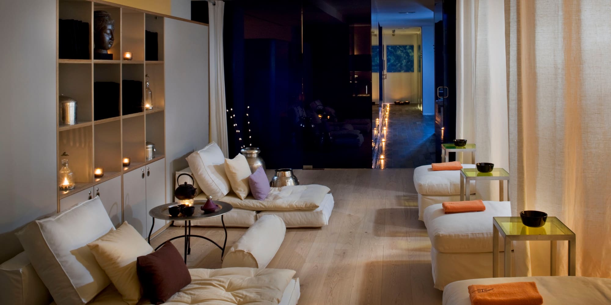 a room with white couches and a black wall