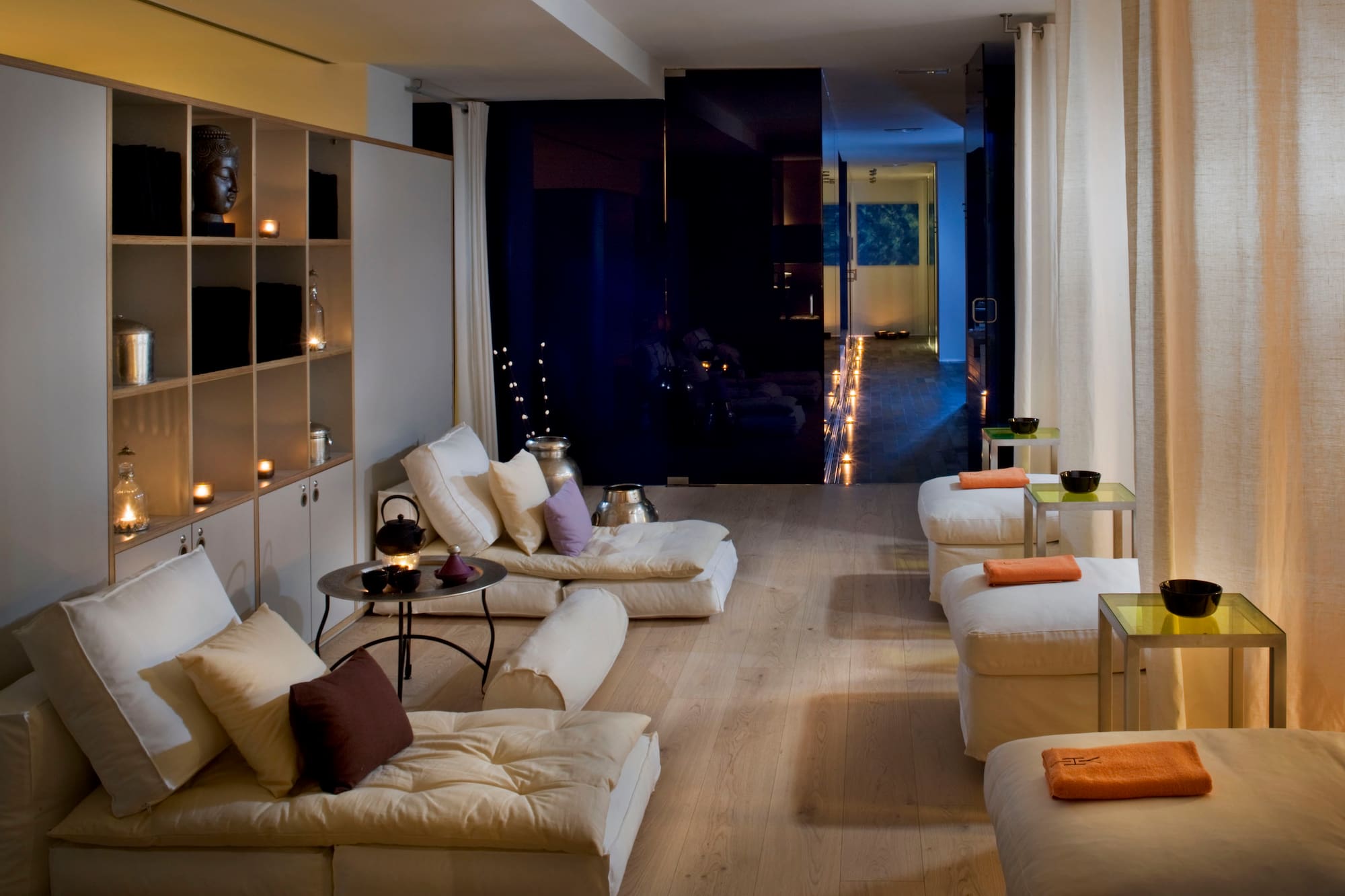 a room with white couches and a black wall