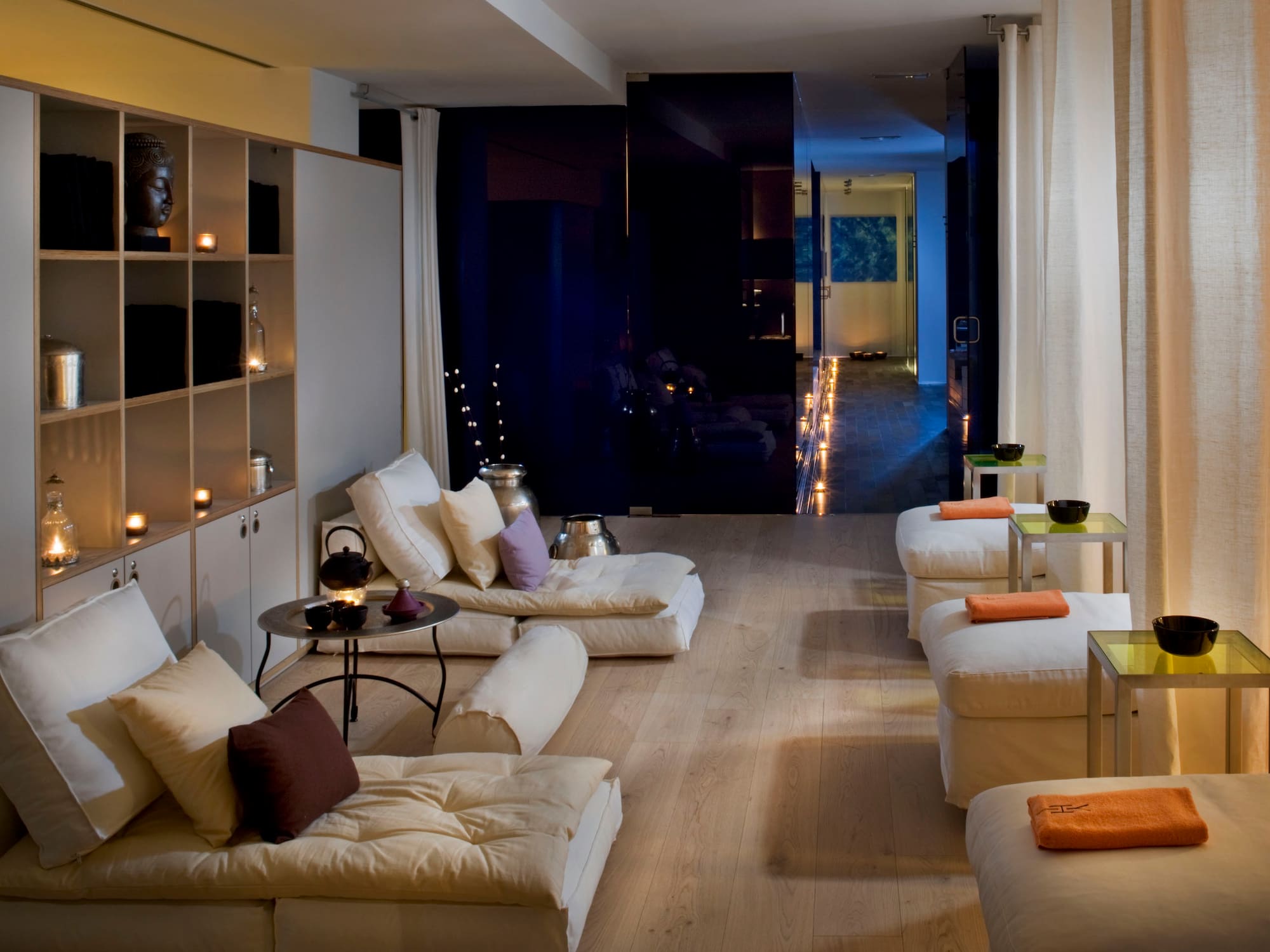 a room with white couches and a black wall