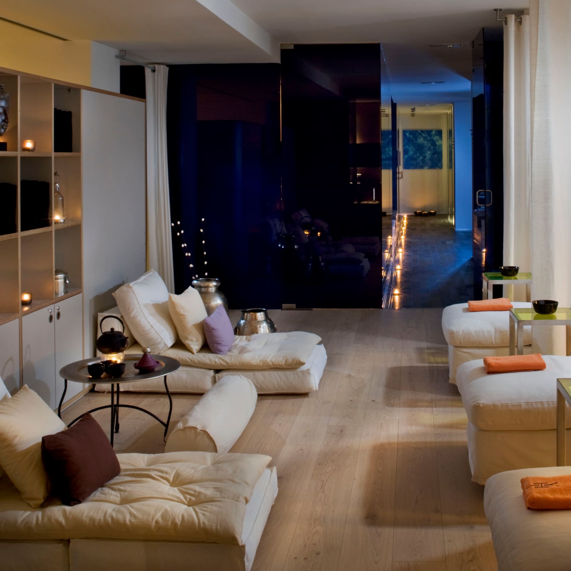 a room with white couches and a black wall