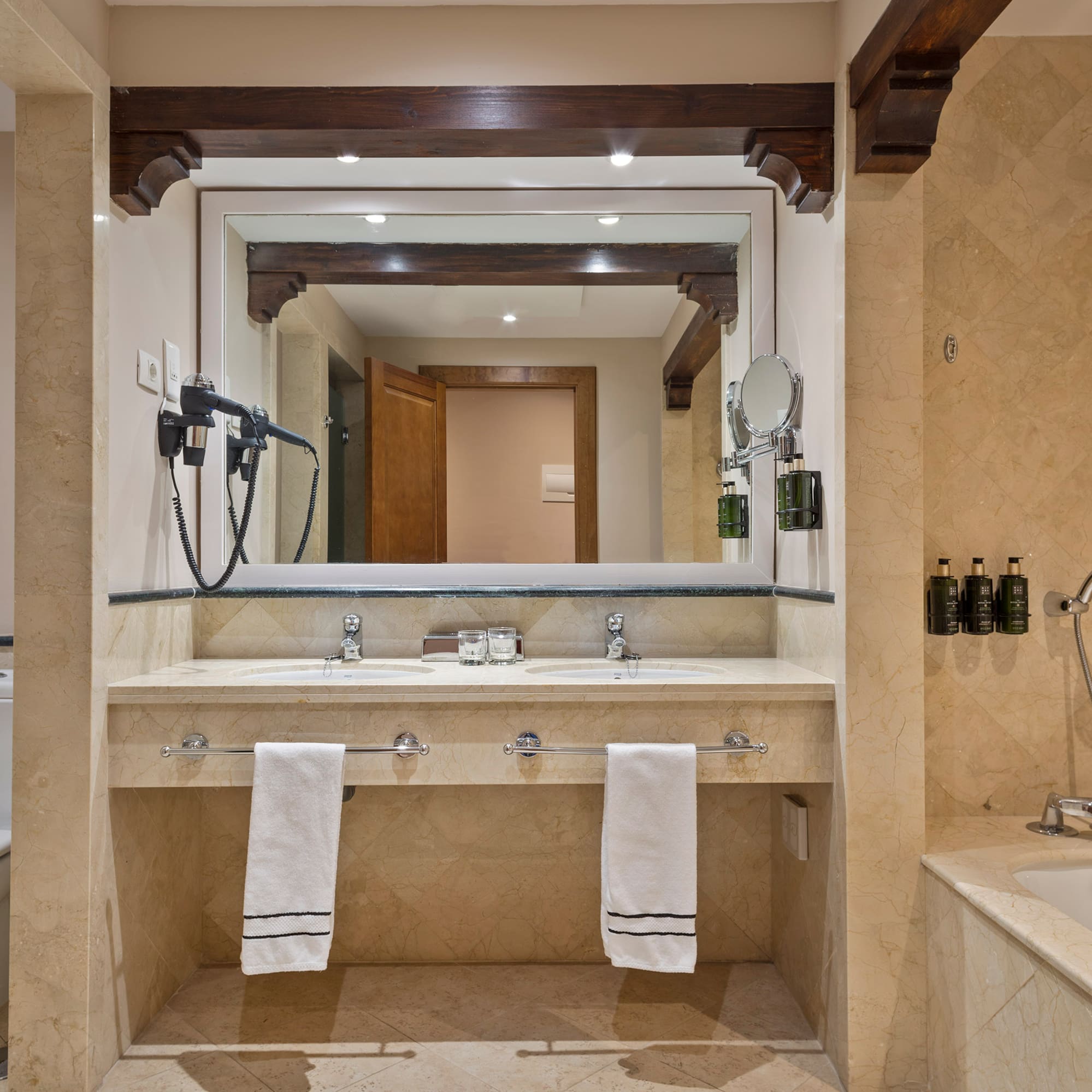 a bathroom with a large mirror and a bathtub