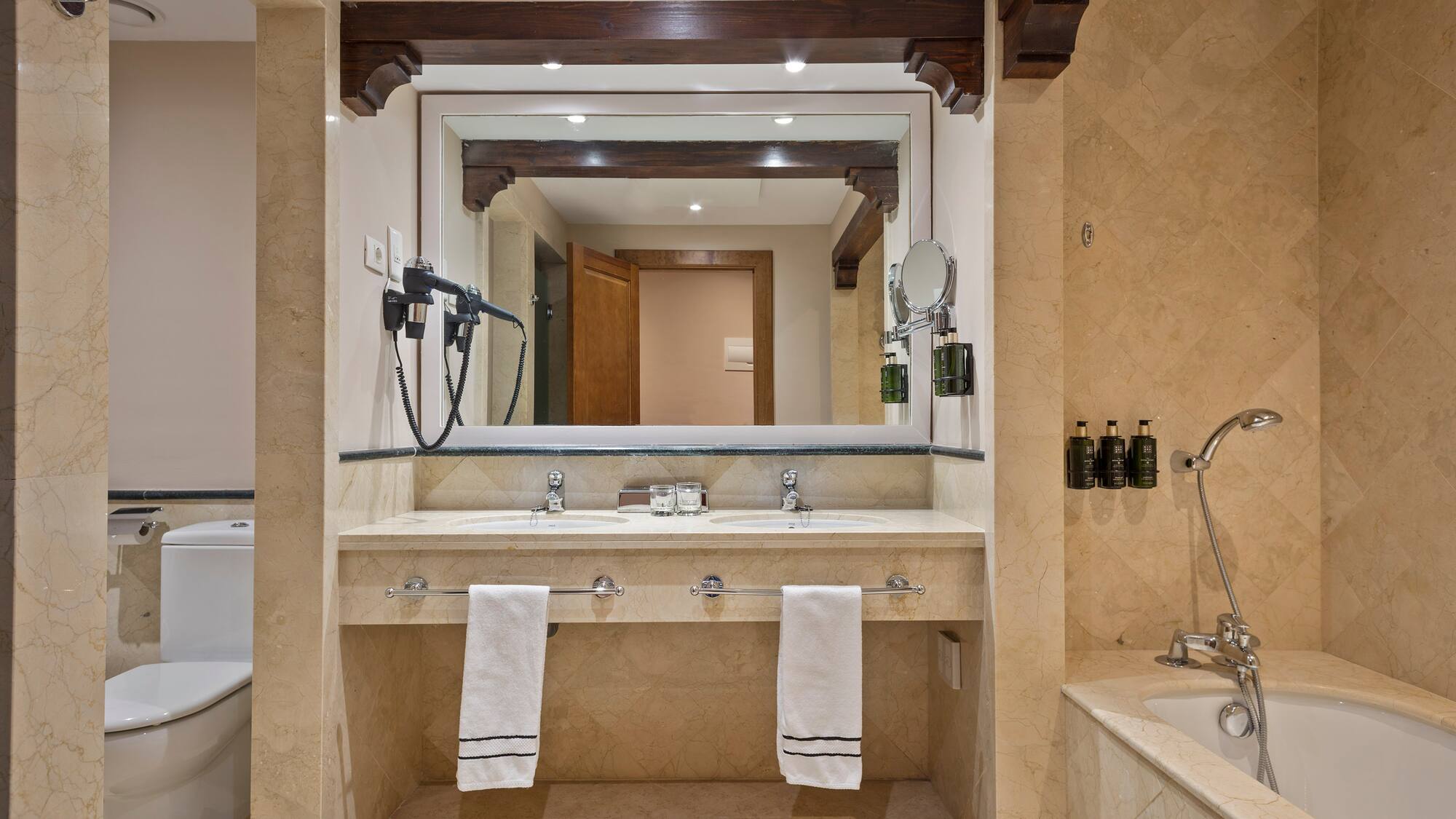 a bathroom with a large mirror and a bathtub