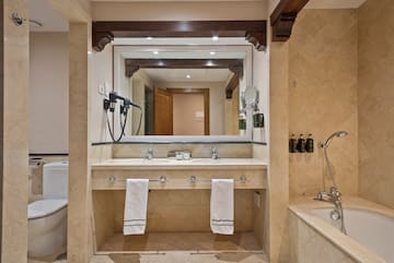 a bathroom with a large mirror and a bathtub