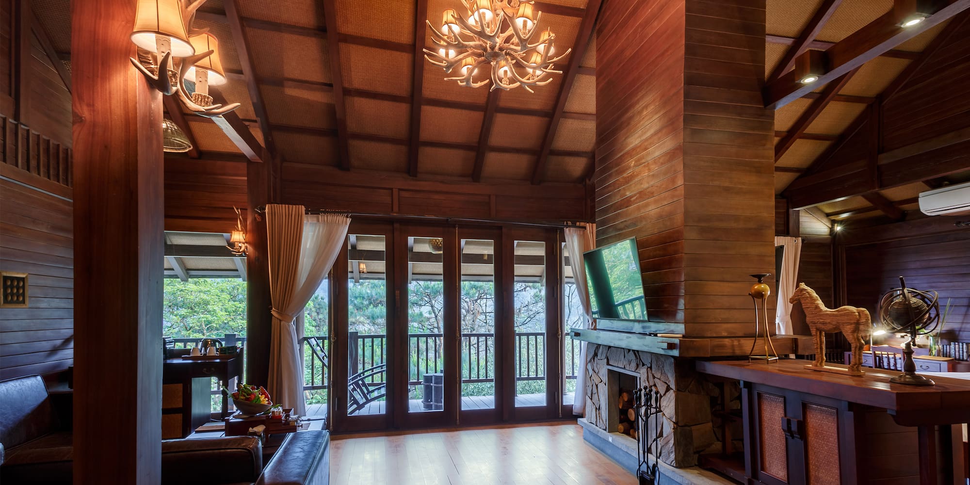 a room with a television and a fireplace