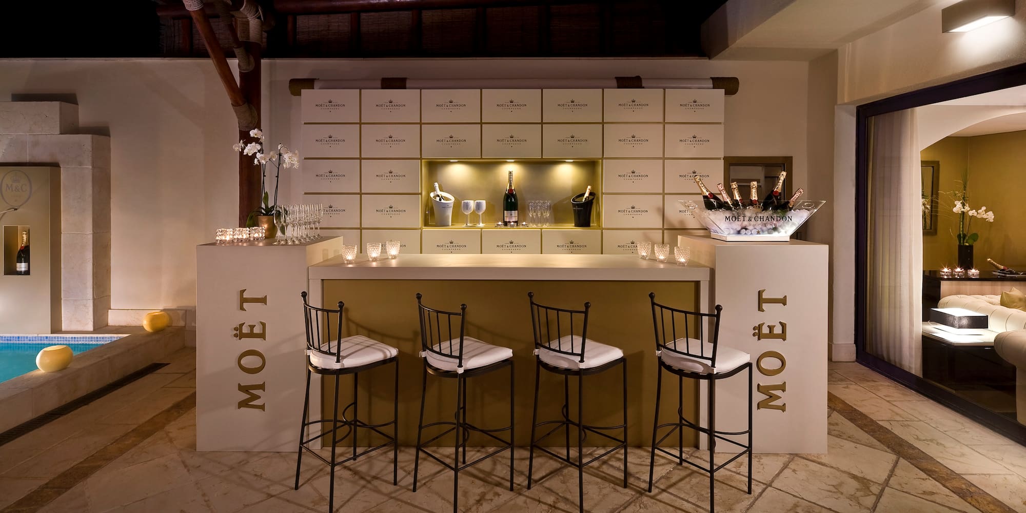 a bar with chairs and a bottle of champagne