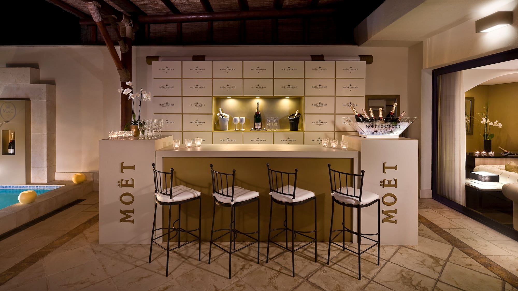 a bar with chairs and a bottle of champagne