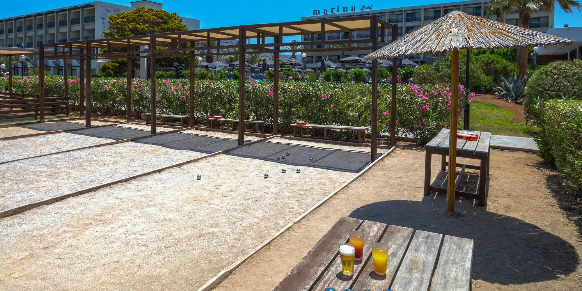 a table with a game of bocce balls and a table with drinks