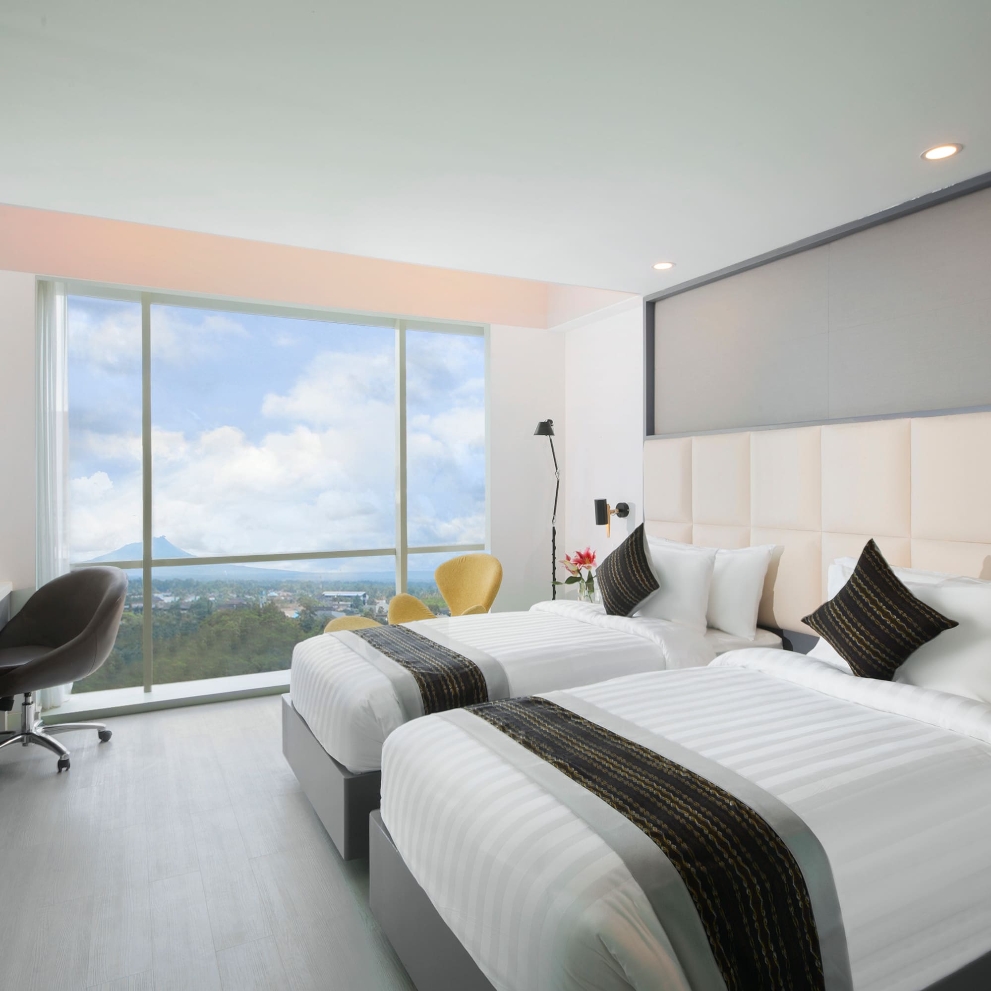 a room with two beds and a window