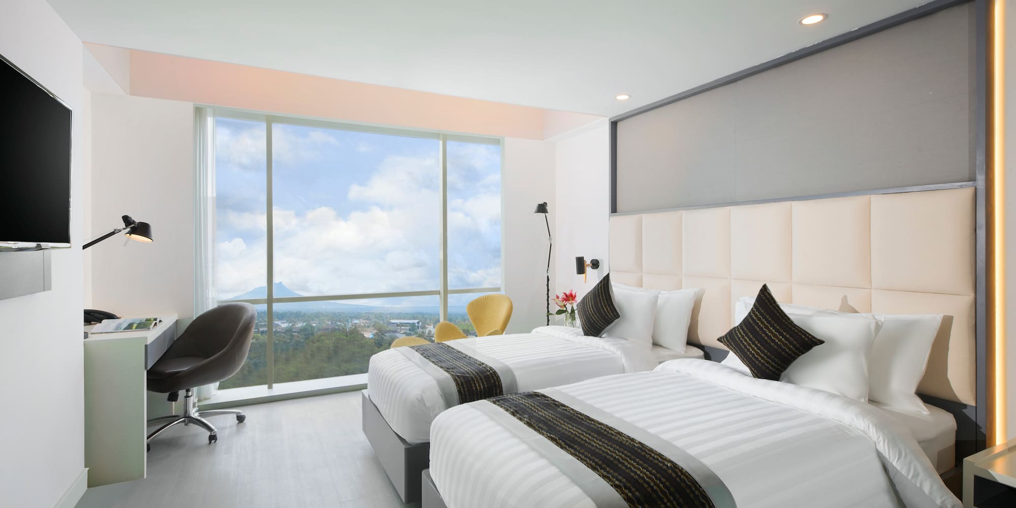 a room with two beds and a window