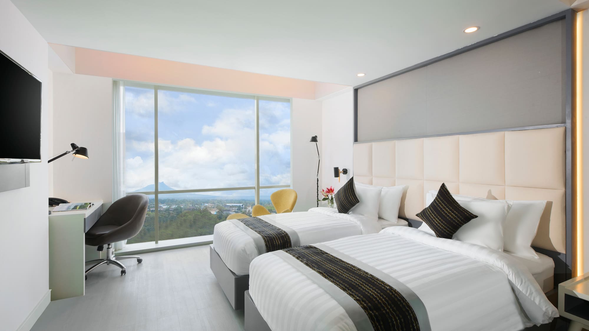 a room with two beds and a window