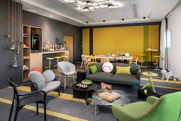 a room with a couch and chairs