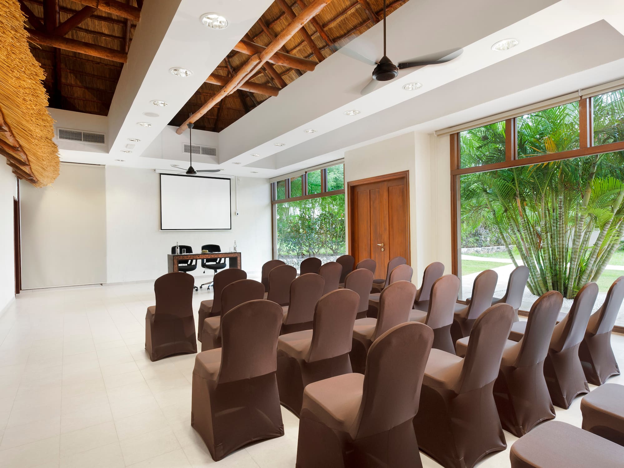 a room with chairs and a projector screen