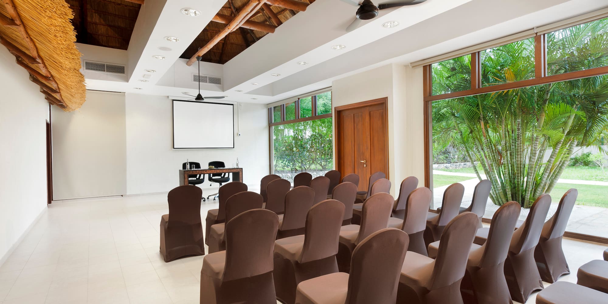 a room with chairs and a projector screen