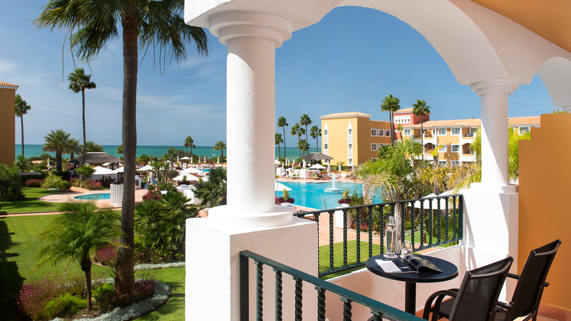 a balcony with a pool and a table