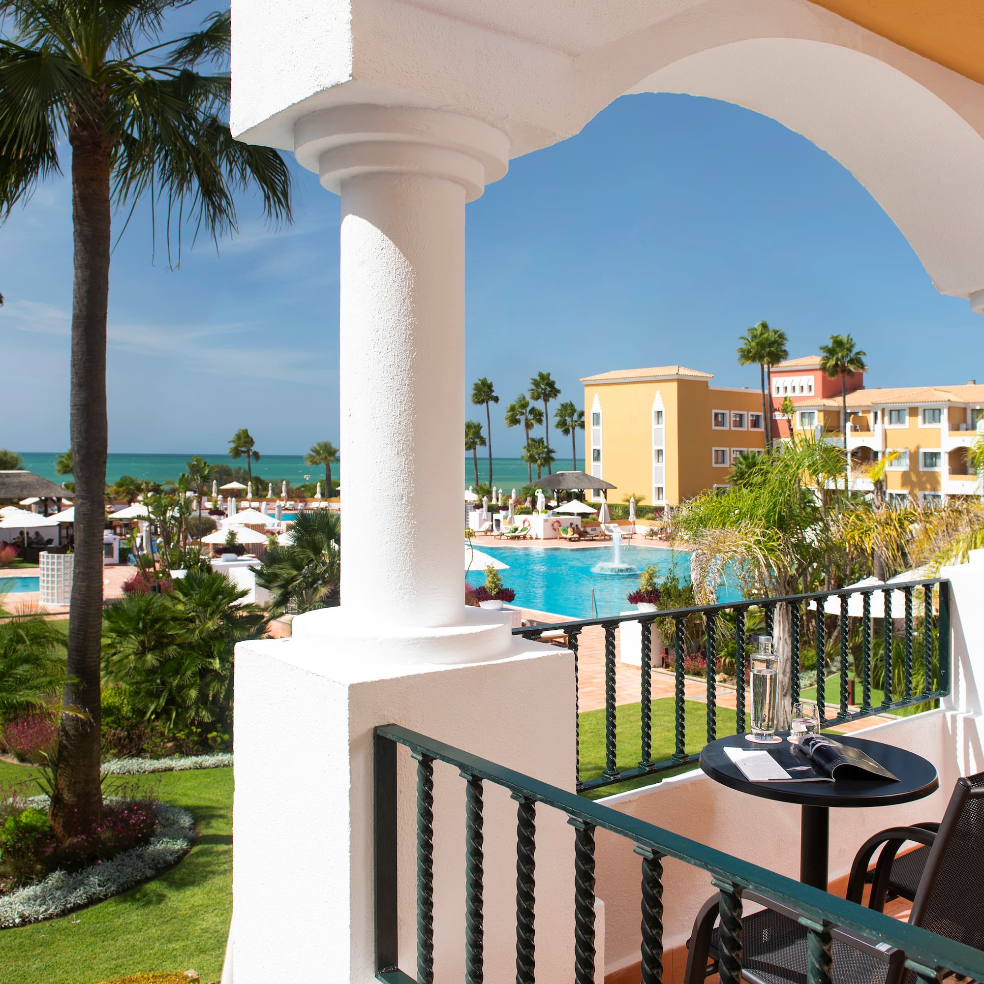a balcony with a pool and a table