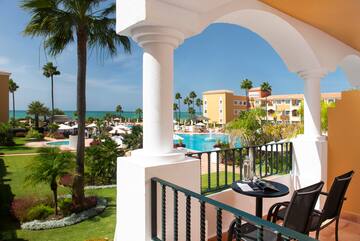 a balcony with a pool and a table