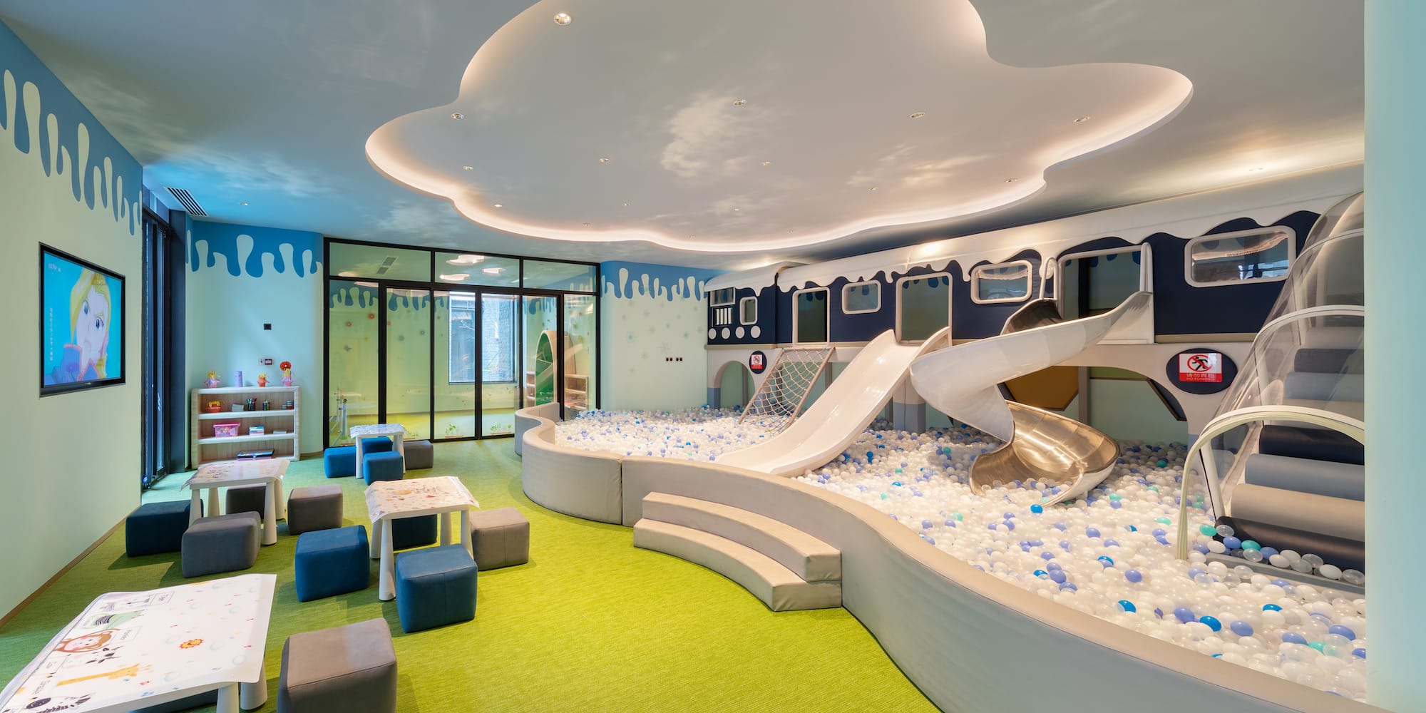 a room with a slide and a pool of balls
