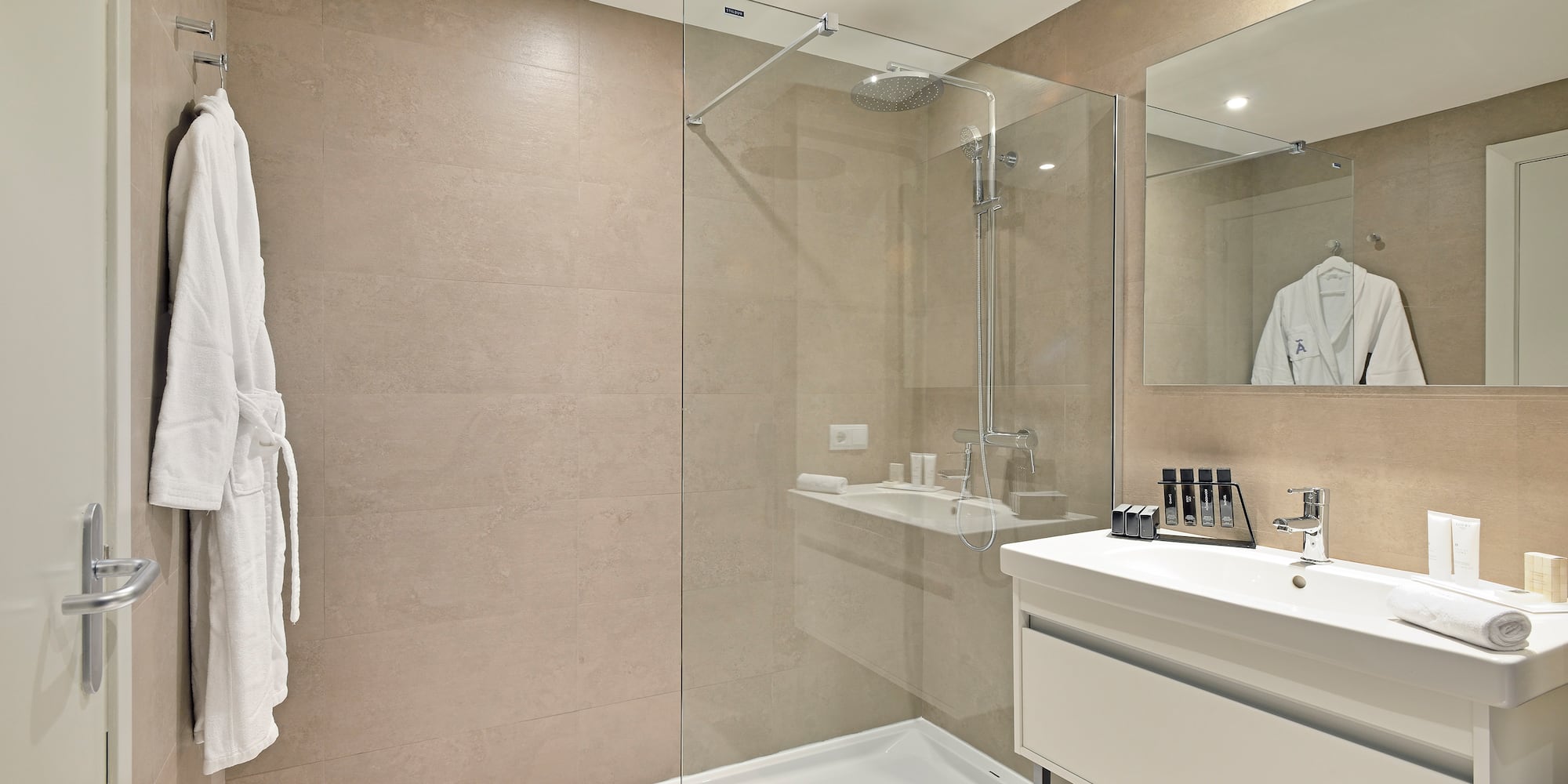 a bathroom with a glass shower and sink