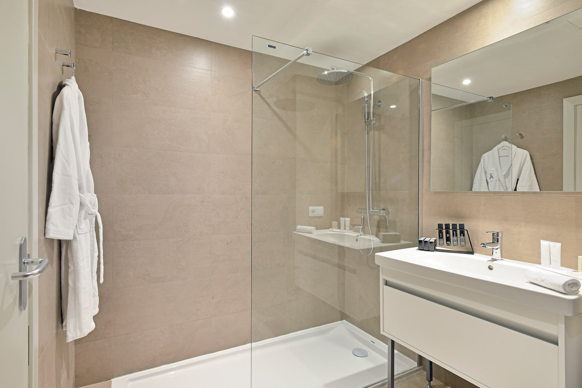 a bathroom with a glass shower and sink