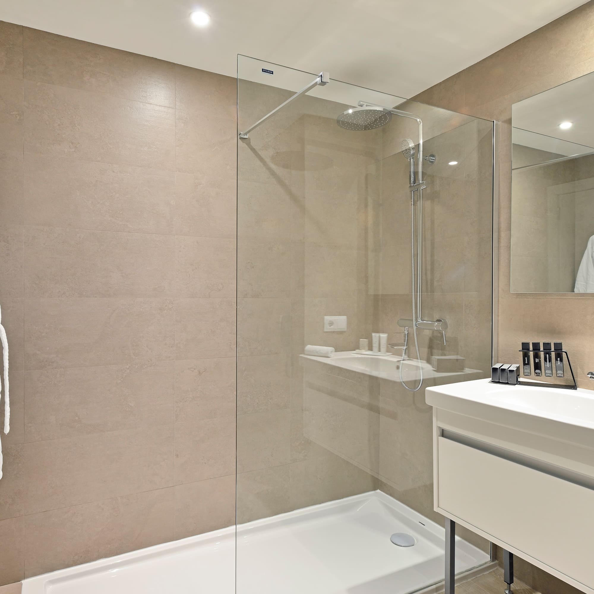 a bathroom with a glass shower and sink