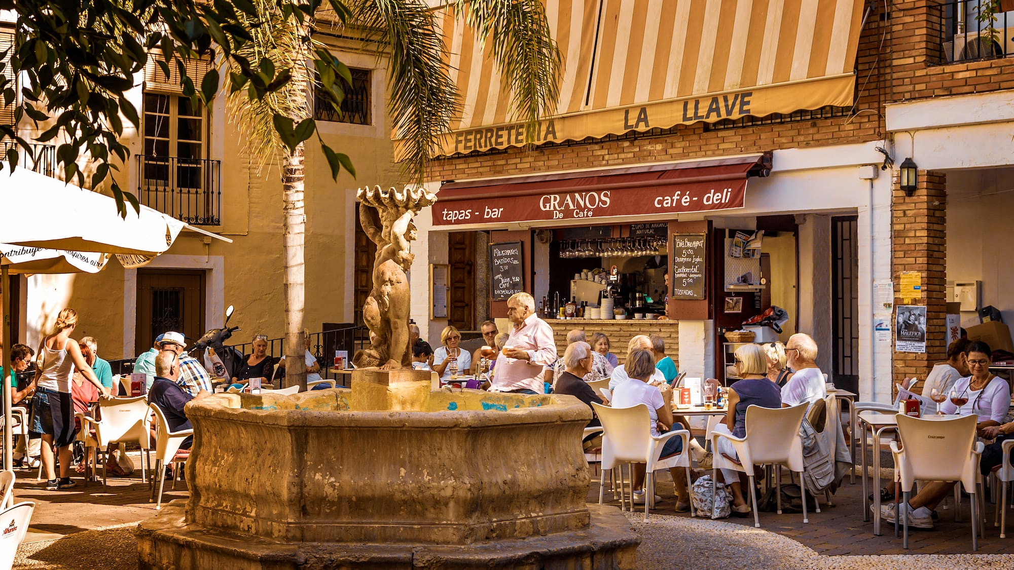 a group of people sitting at tables outside a building