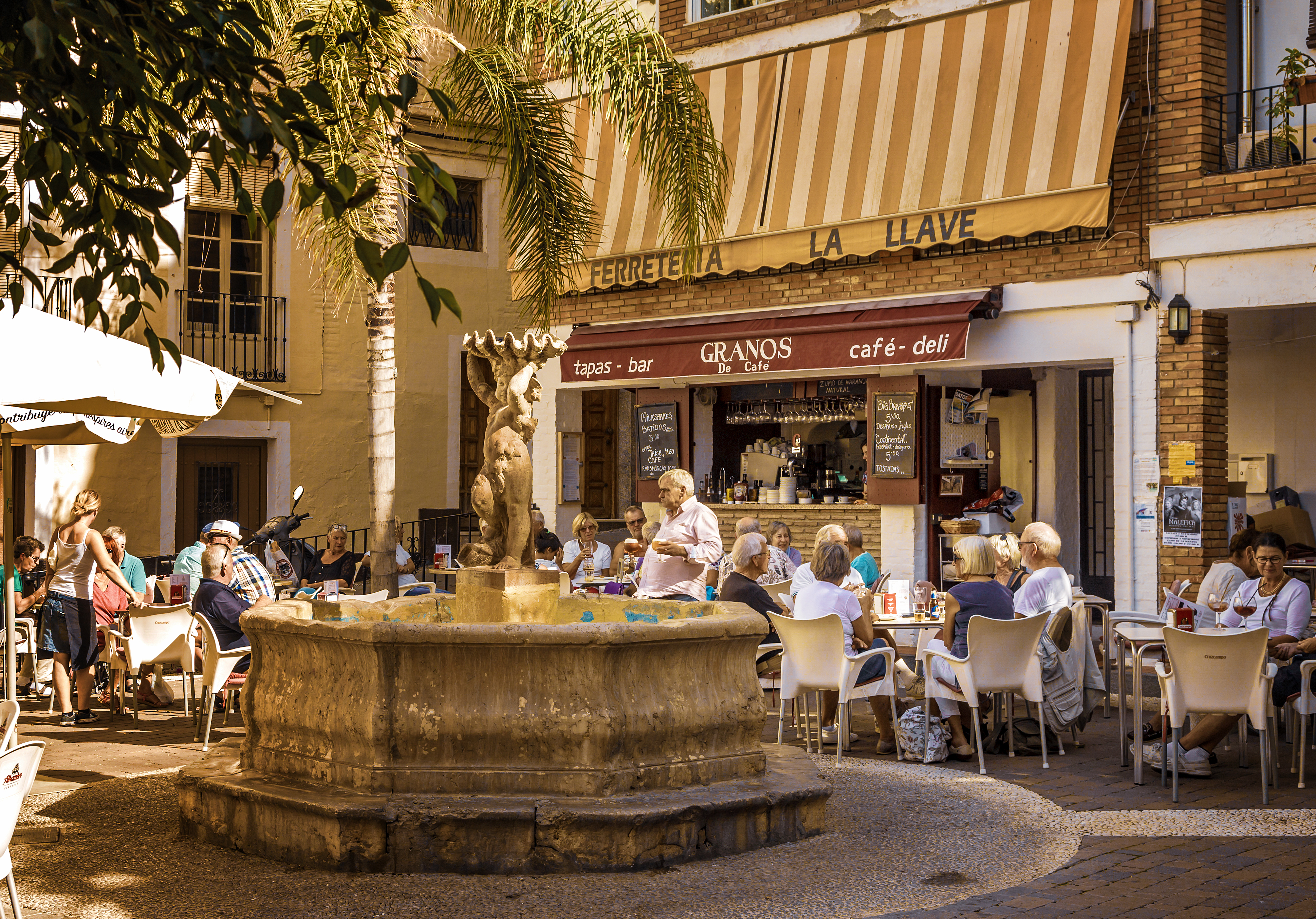 a group of people sitting at tables outside a building