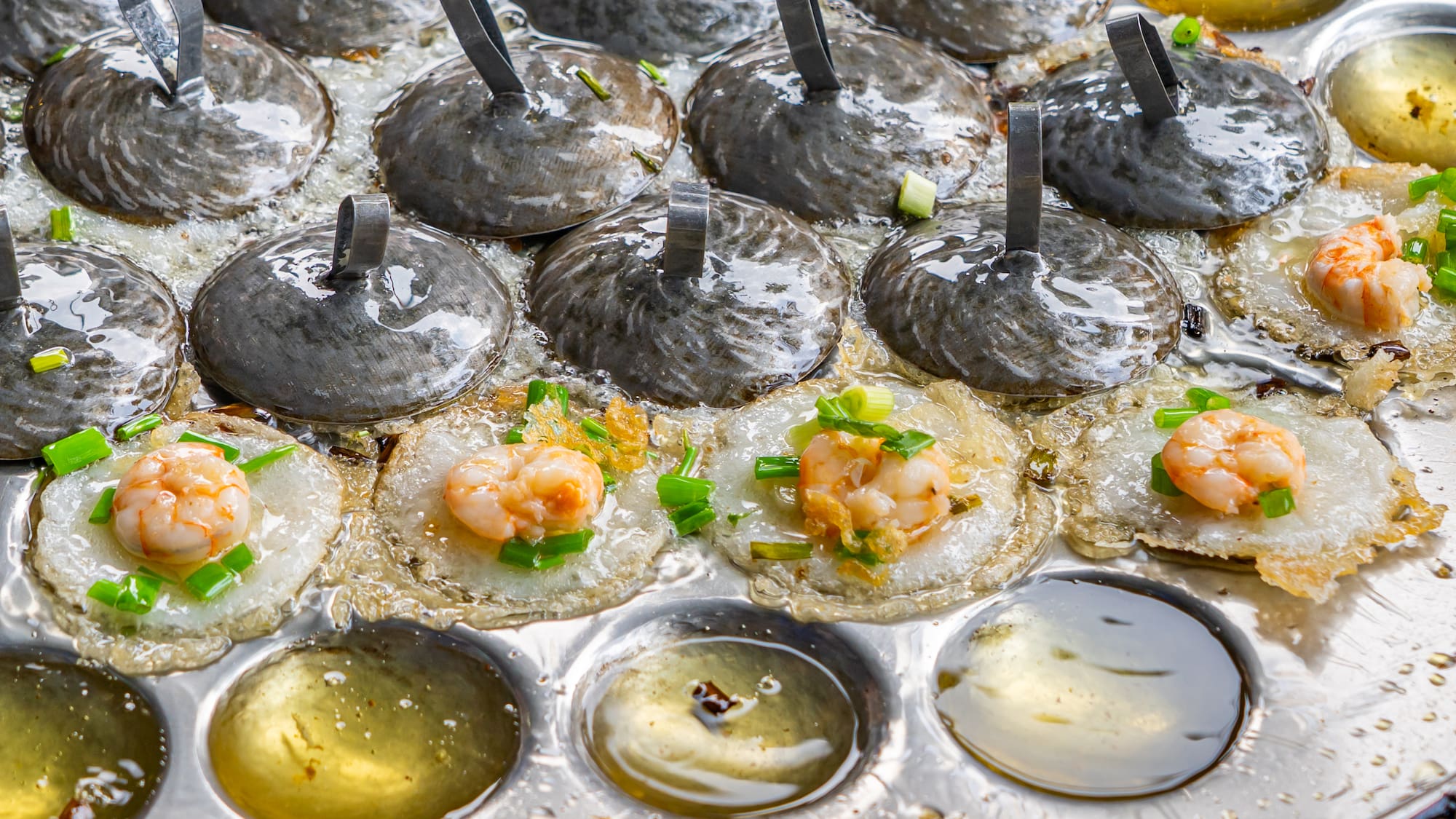 a pan of food with shrimp and green onions