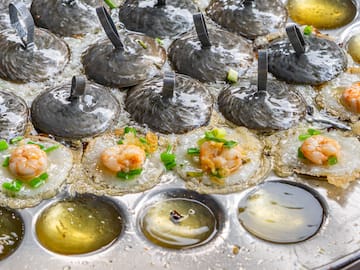 a pan of food with shrimp and green onions