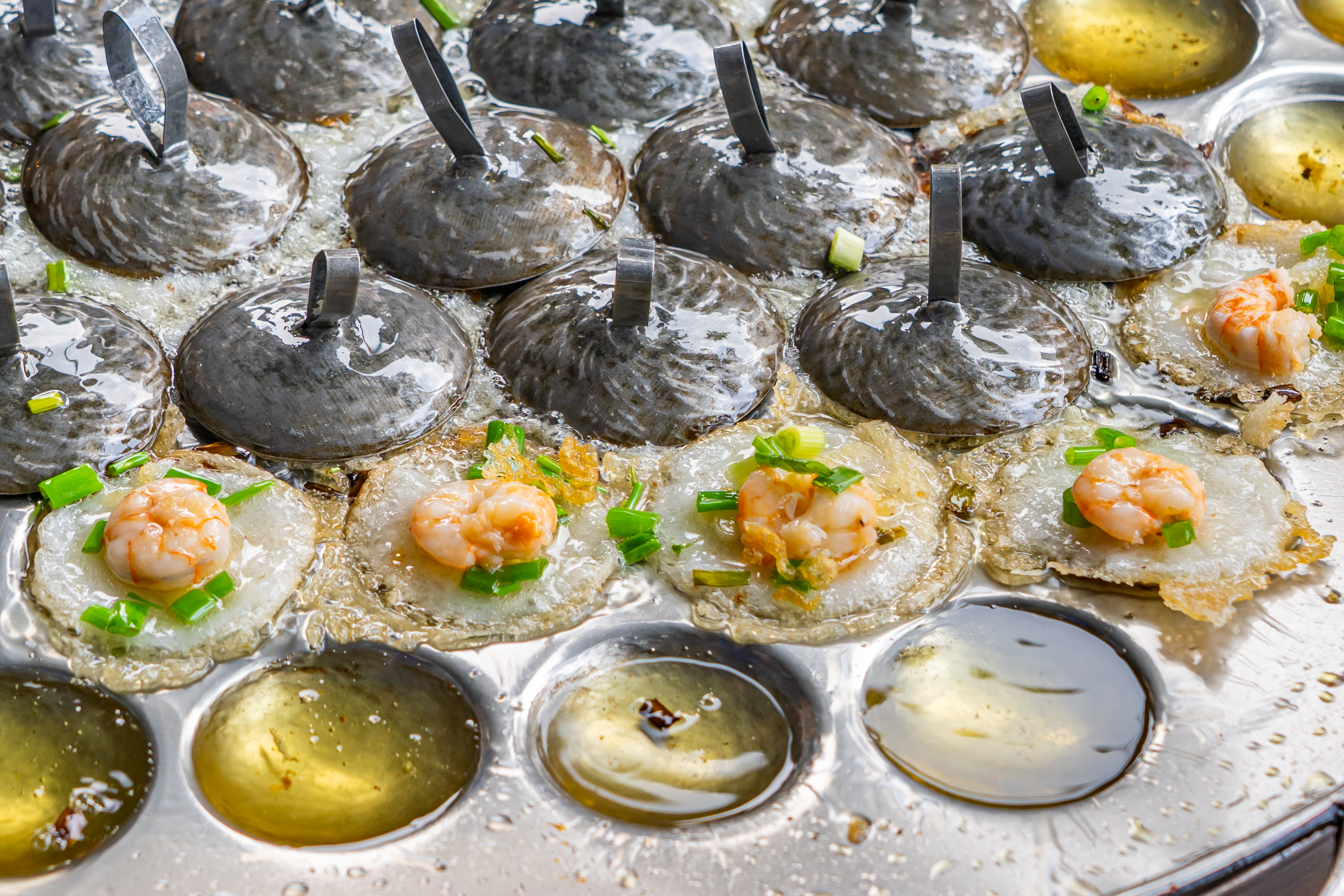 a pan of food with shrimp and green onions