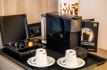 a coffee machine and coffee cups on a table