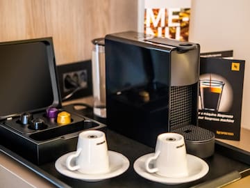 a coffee machine and coffee cups on a table