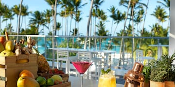 a table with fruit and drinks on it