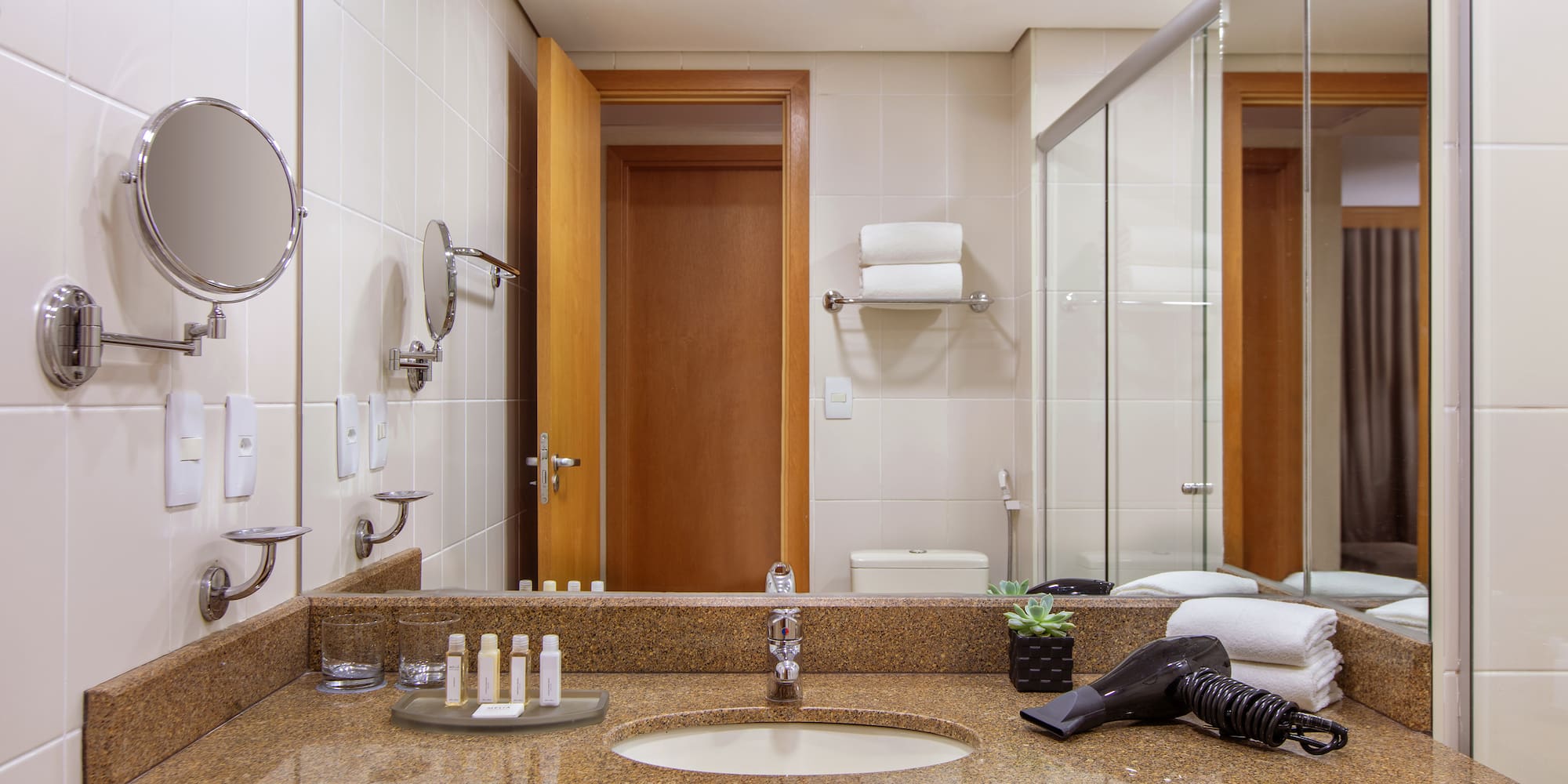 a bathroom with a mirror and a blow dryer