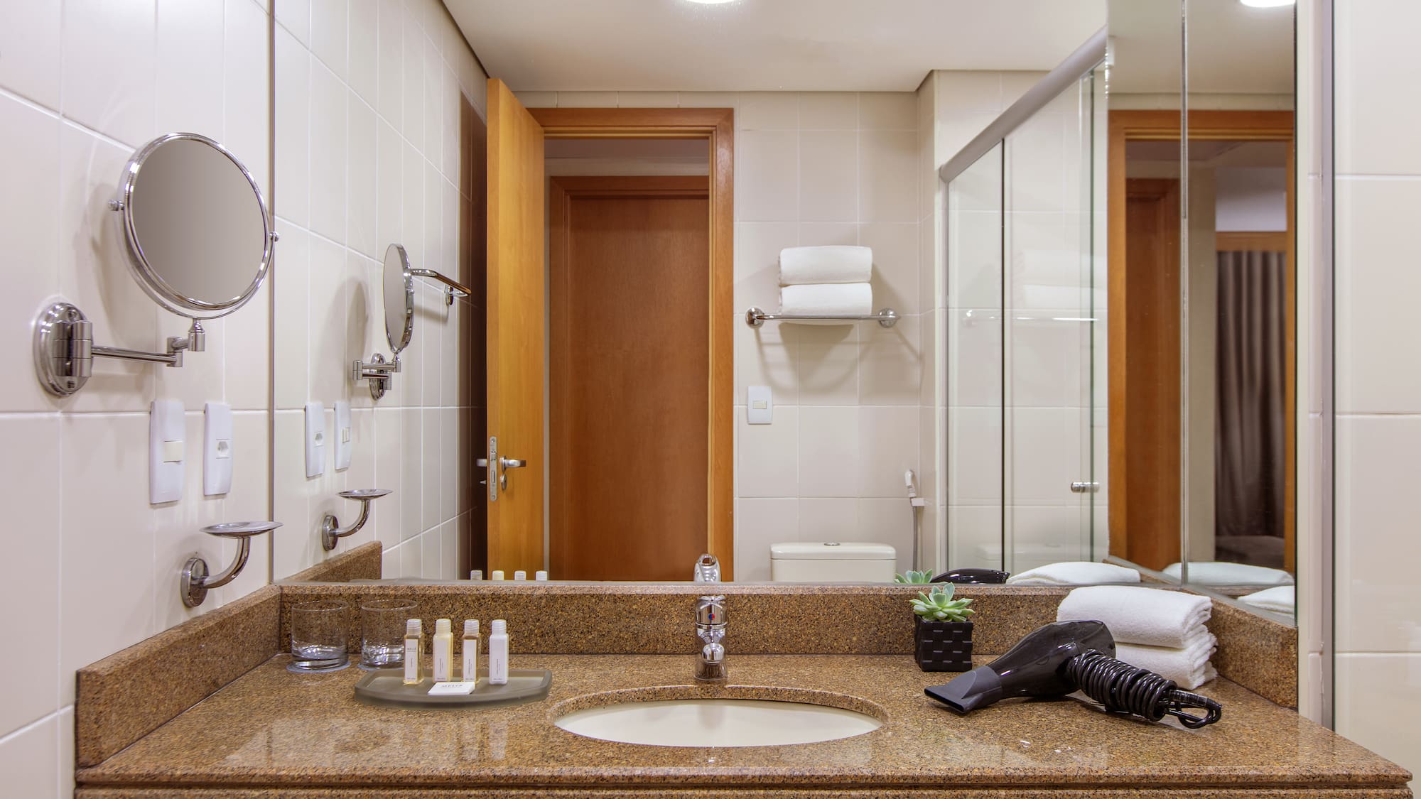 a bathroom with a mirror and a blow dryer