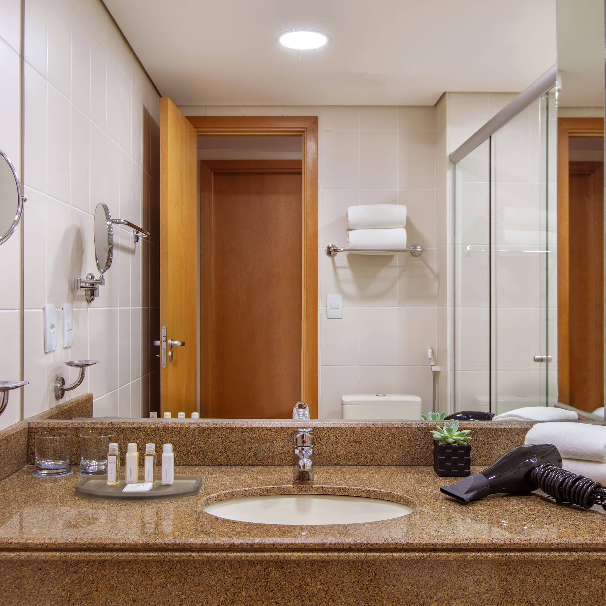 a bathroom with a mirror and a blow dryer