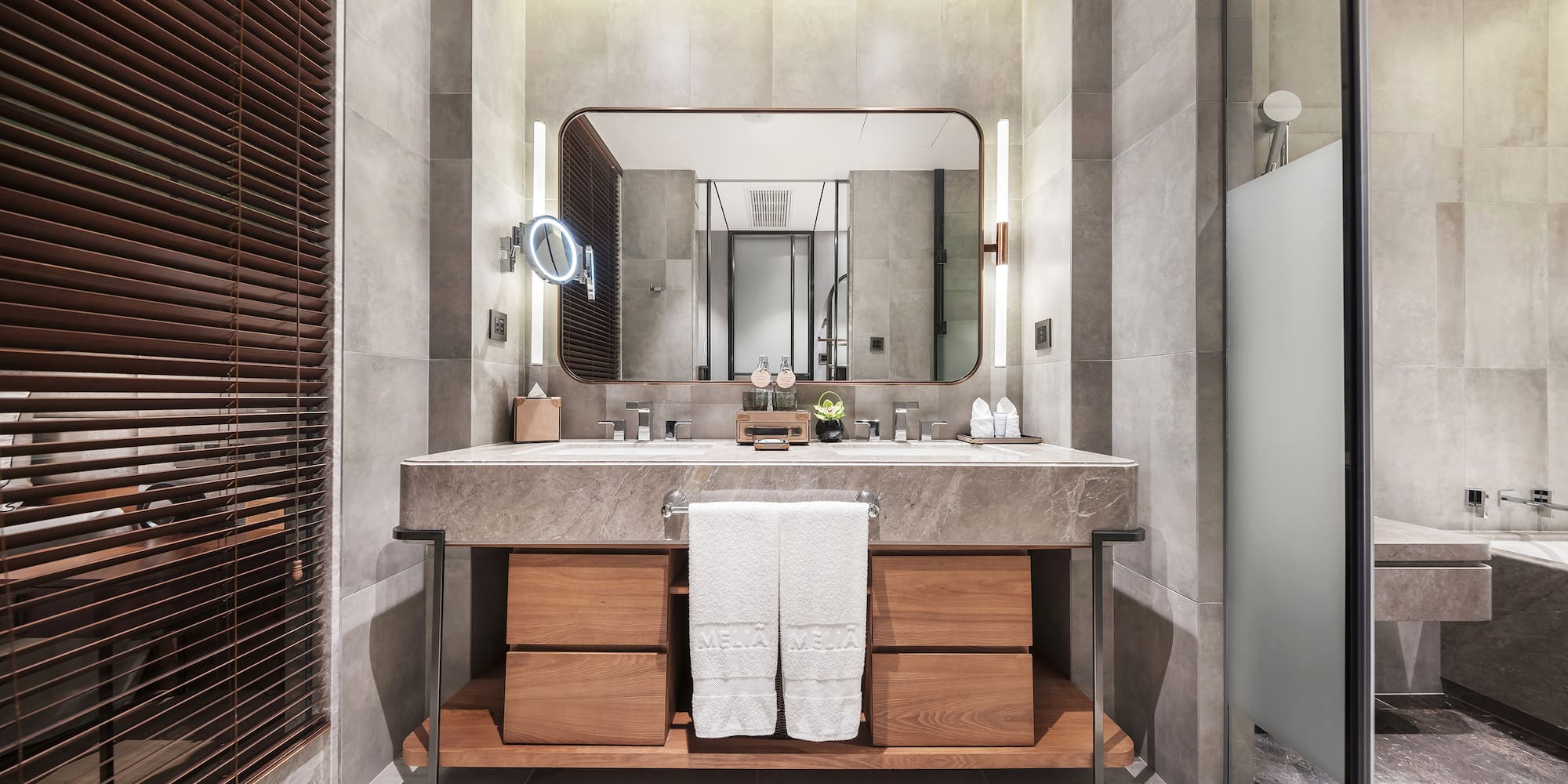 a bathroom with a large mirror and a sink