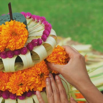 a person making a flower arrangement