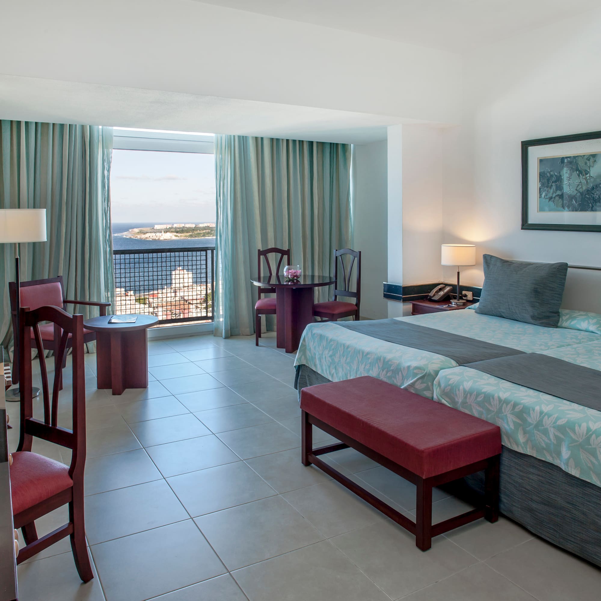 a bedroom with a bed and chairs and a table