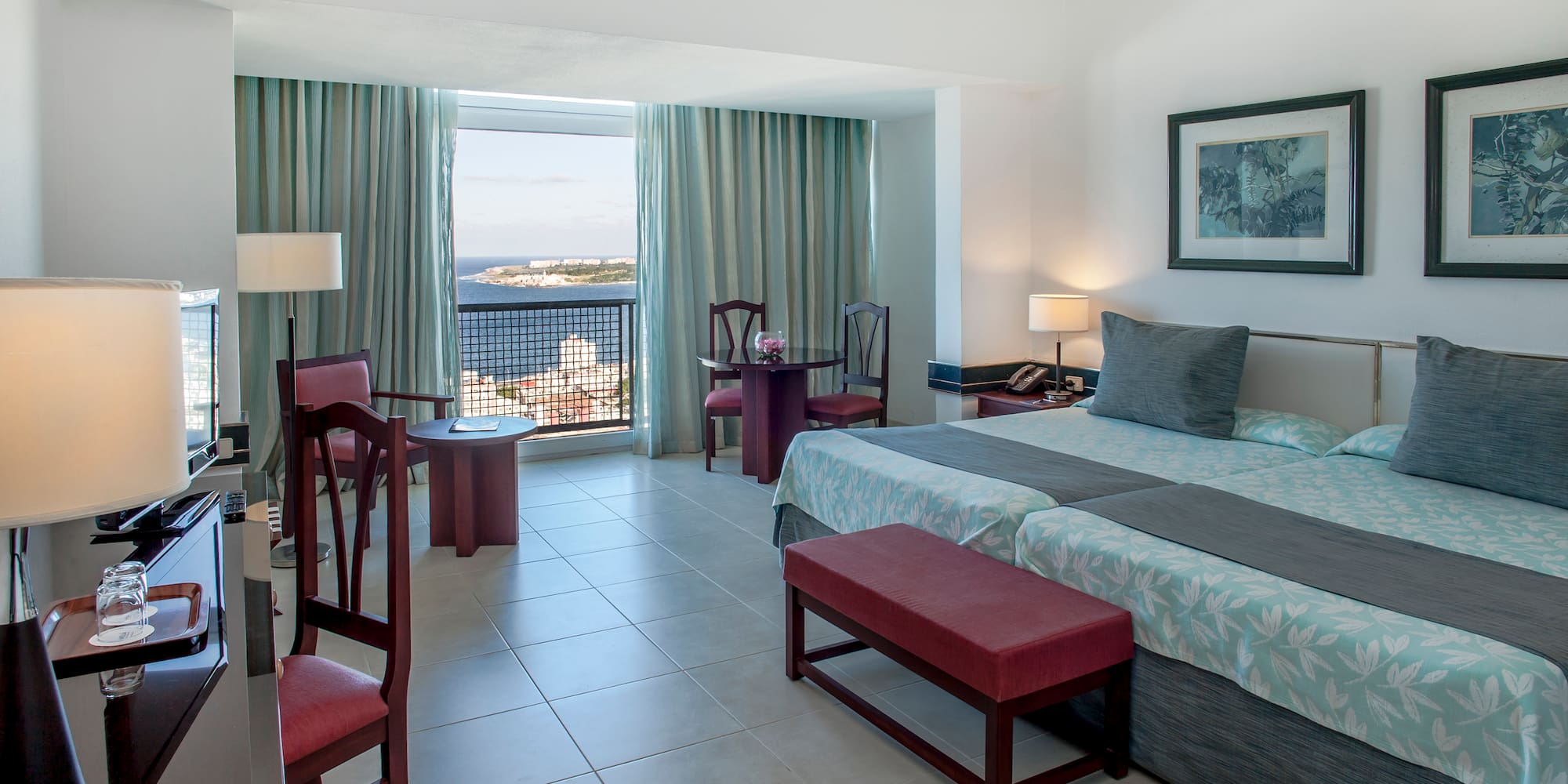 a bedroom with a bed and chairs and a table