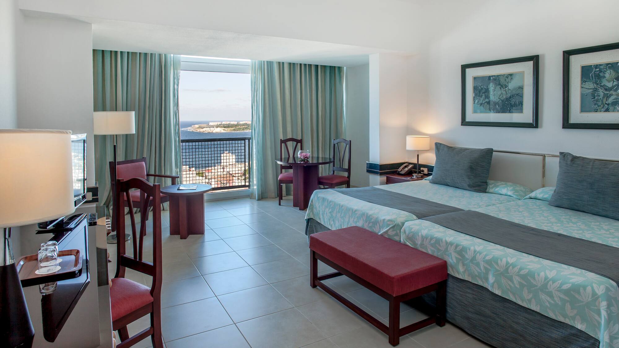 a bedroom with a bed and chairs and a table