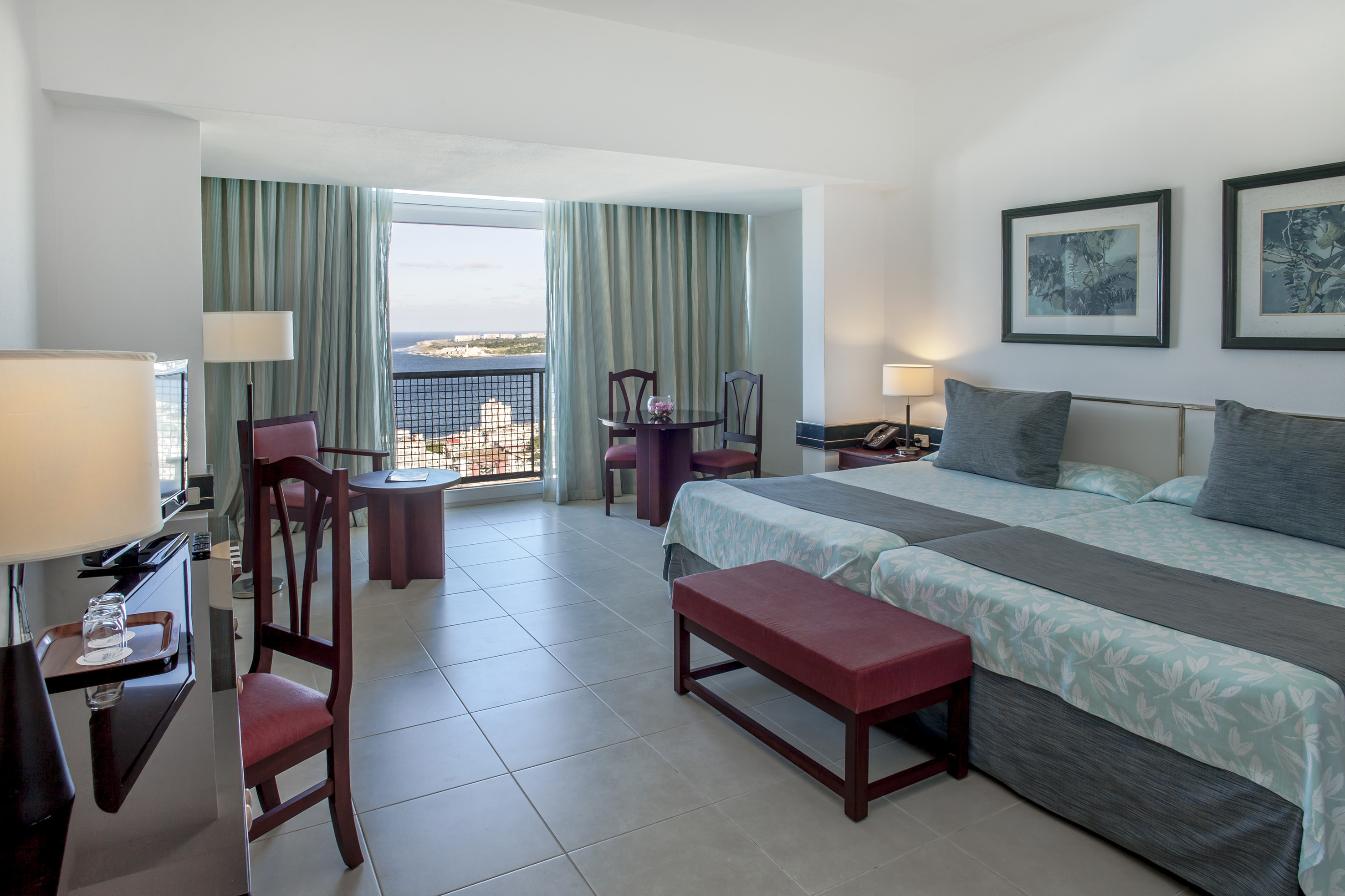 a bedroom with a bed and chairs and a table