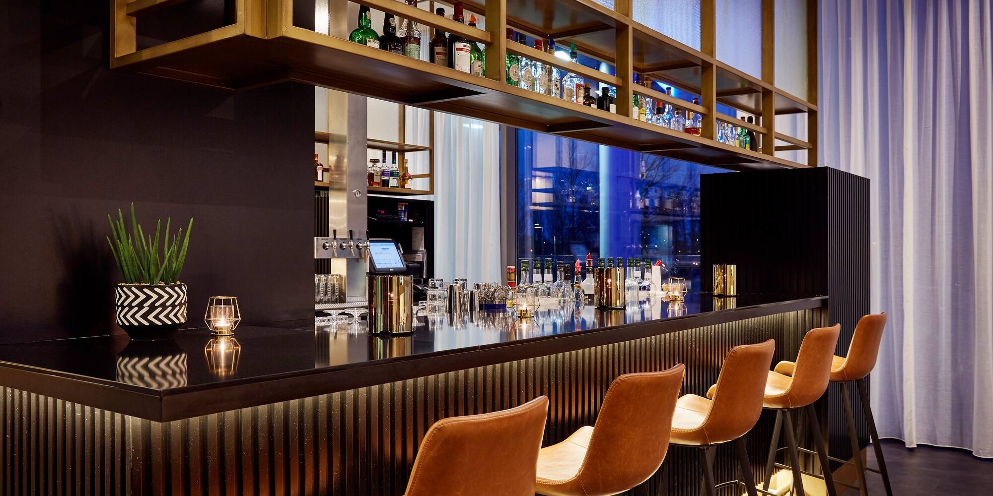 a bar with chairs and a shelf