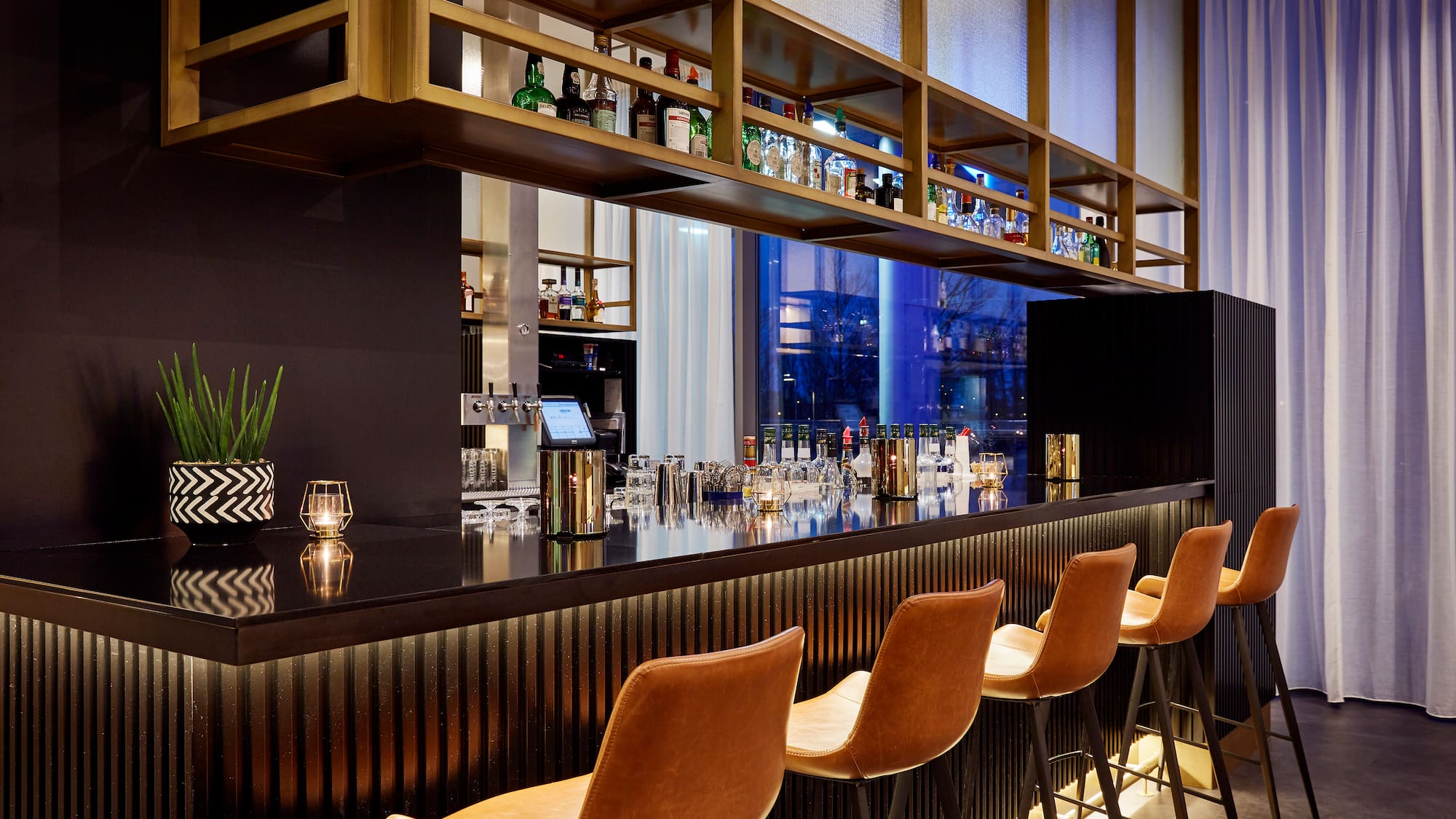 a bar with chairs and a shelf