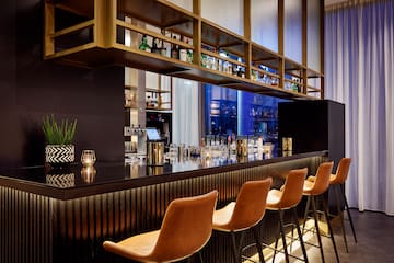 a bar with chairs and a shelf